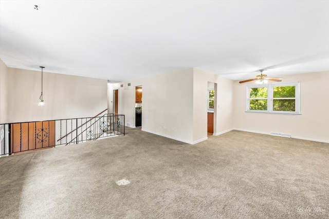 carpeted empty room with ceiling fan