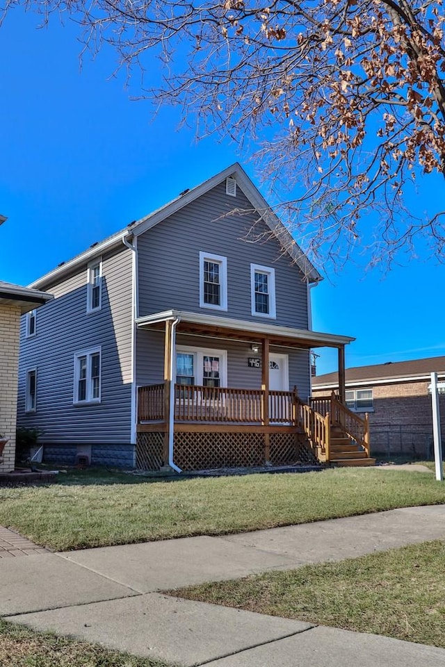 view of front facade with covered porch and a front yard