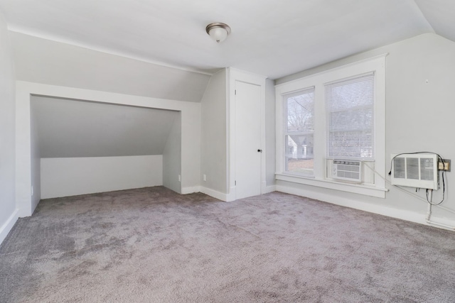 additional living space featuring a wall mounted AC, cooling unit, light colored carpet, and lofted ceiling