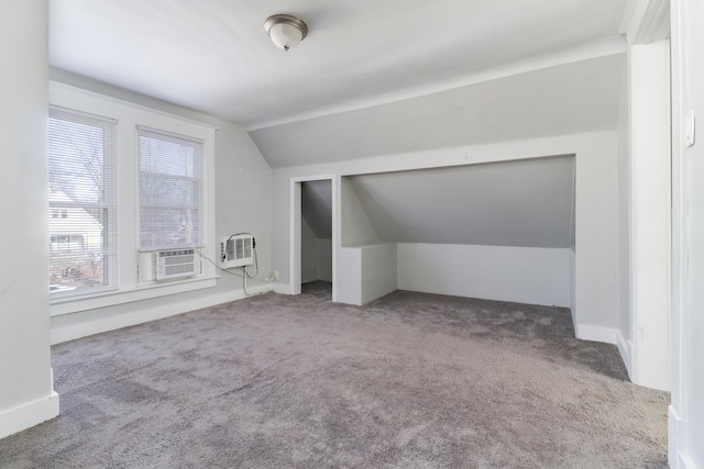 additional living space featuring cooling unit, a wall unit AC, carpet, and lofted ceiling