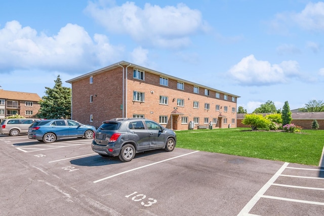 view of vehicle parking featuring a lawn