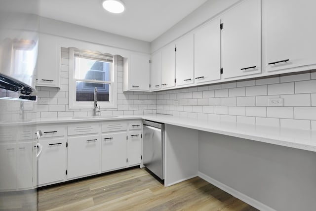 kitchen with sink, light hardwood / wood-style flooring, stainless steel dishwasher, decorative backsplash, and white cabinets