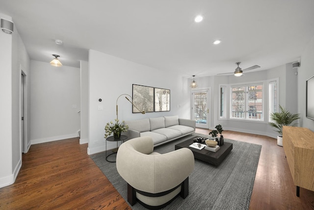 living area featuring recessed lighting, a ceiling fan, baseboards, and wood finished floors