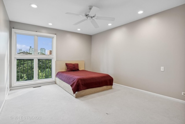 bedroom featuring ceiling fan and carpet