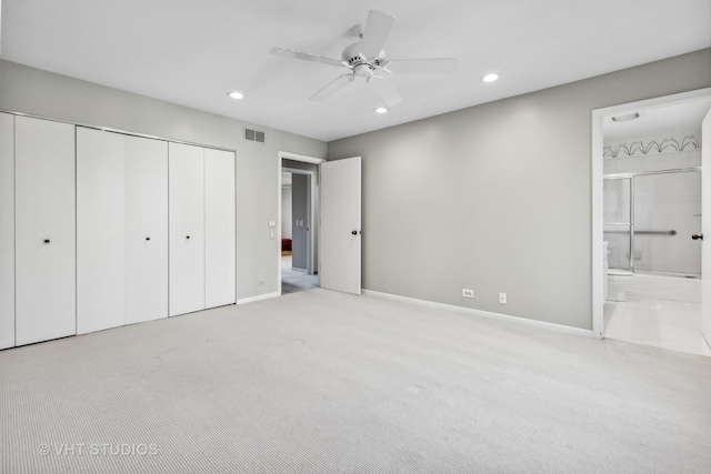 unfurnished bedroom featuring ceiling fan, connected bathroom, and light carpet