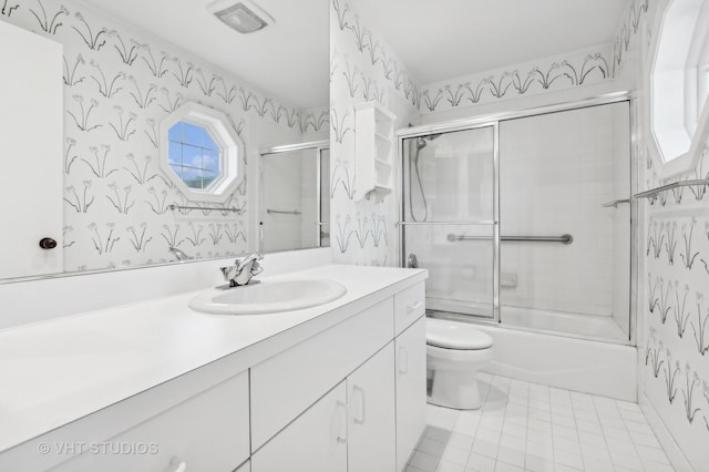 full bathroom featuring vanity, enclosed tub / shower combo, and toilet