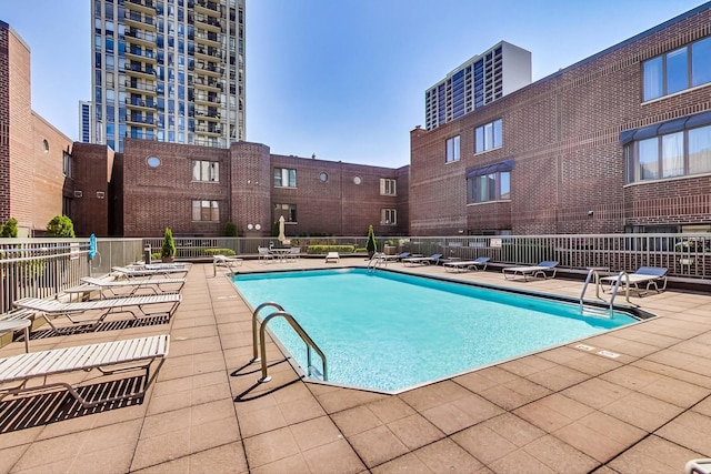 view of swimming pool featuring a patio area