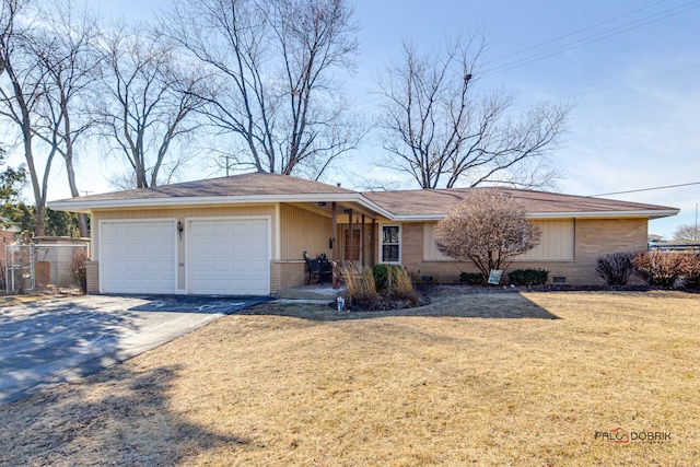 ranch-style home featuring a garage and a front lawn