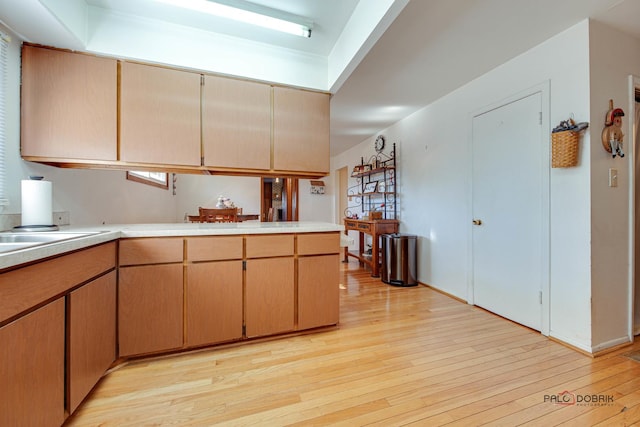 kitchen featuring light hardwood / wood-style floors and kitchen peninsula