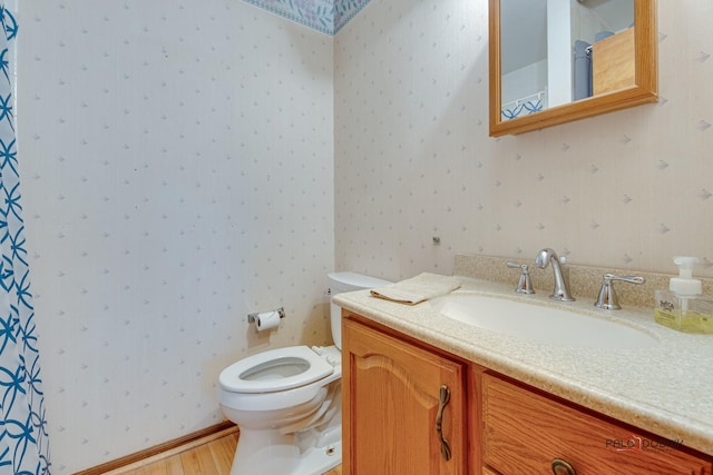 bathroom featuring hardwood / wood-style flooring, vanity, and toilet