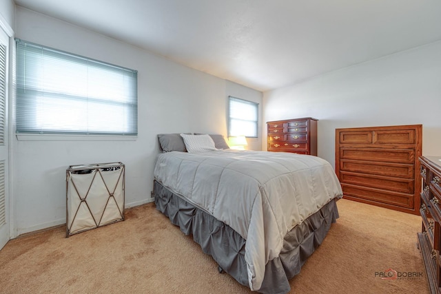 bedroom featuring light carpet