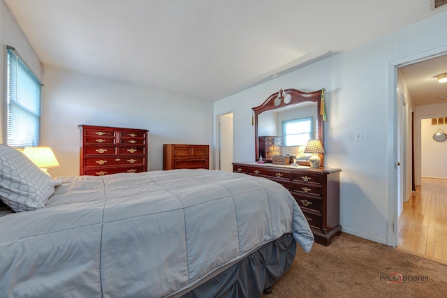 bedroom featuring light carpet