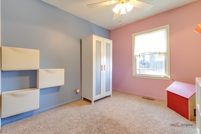 unfurnished bedroom with light carpet and ceiling fan