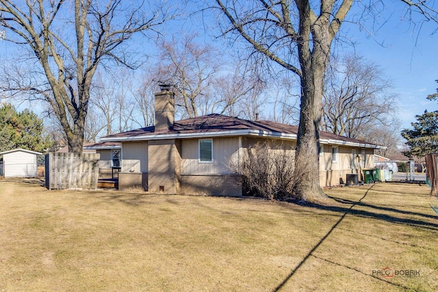 rear view of property with a yard and central air condition unit