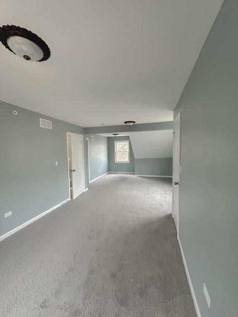 additional living space with carpet floors and vaulted ceiling