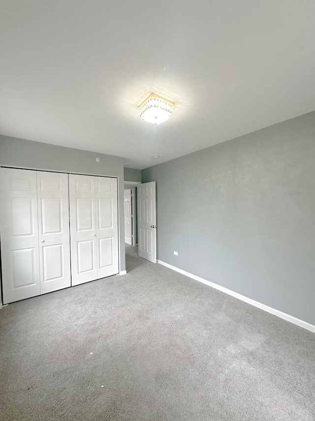 unfurnished bedroom with carpet and a closet