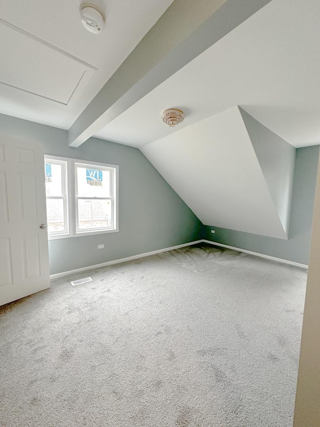 bonus room with carpet floors and vaulted ceiling