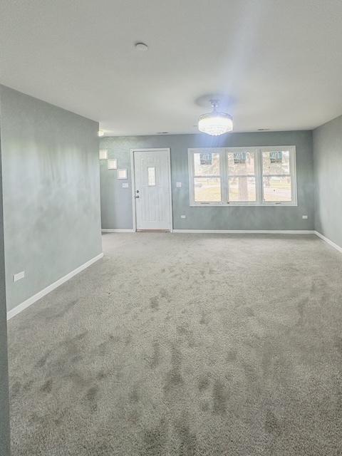 unfurnished living room with carpet floors