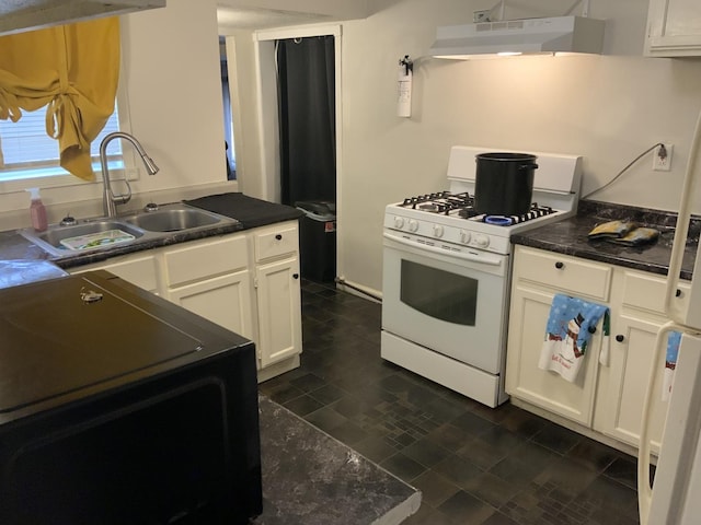 kitchen featuring white range with gas stovetop, sink, white cabinets, and exhaust hood