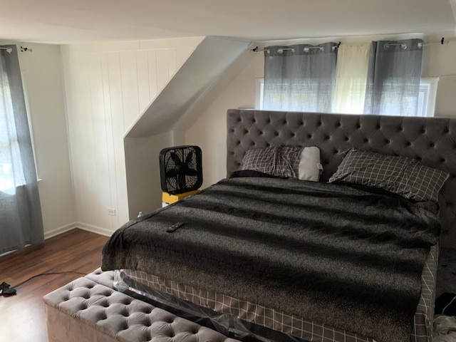 bedroom with dark wood-type flooring