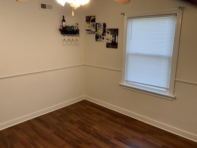 empty room featuring dark hardwood / wood-style floors and ceiling fan