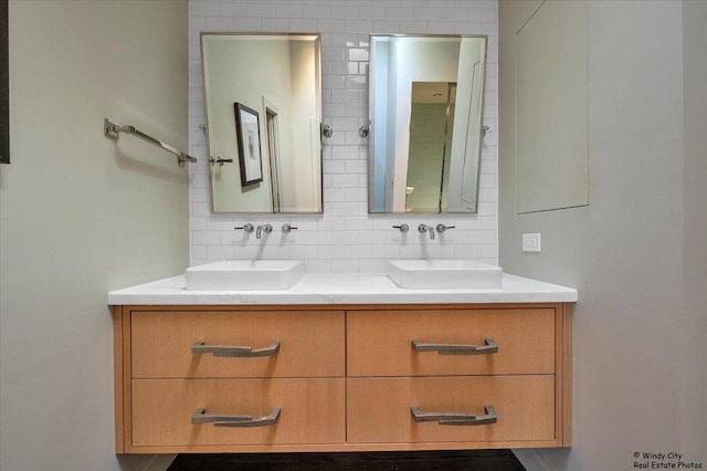 bathroom with tasteful backsplash and vanity