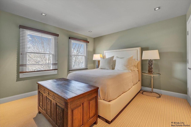 carpeted bedroom with multiple windows