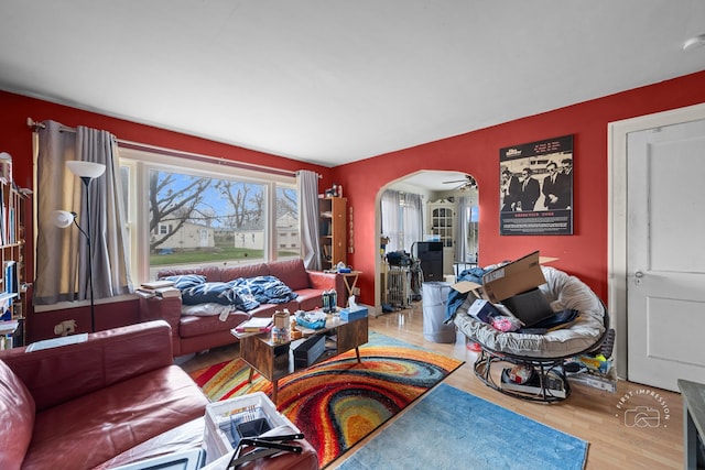 living room featuring hardwood / wood-style floors and ceiling fan