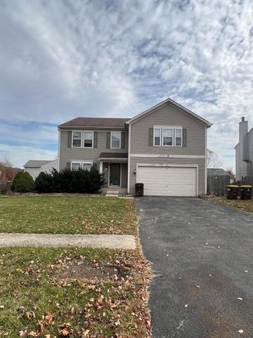 view of front property featuring a garage and a front lawn