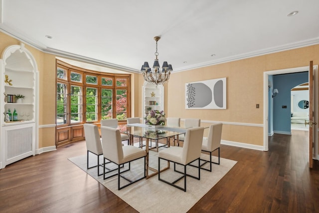 dining space with built in shelves, crown molding, dark hardwood / wood-style flooring, and an inviting chandelier