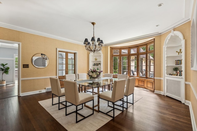 dining room featuring french doors, built in shelves, dark wood-type flooring, crown molding, and a notable chandelier