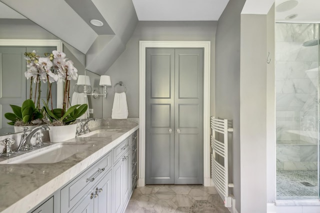 bathroom with vanity, radiator, and a shower with shower door