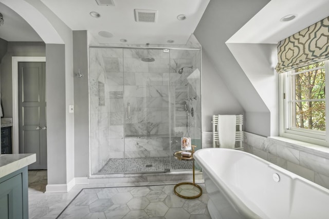 bathroom featuring vanity, separate shower and tub, and radiator heating unit