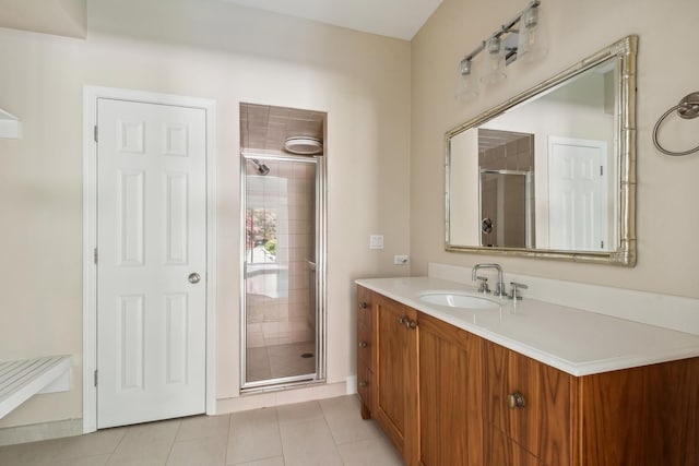 bathroom with tile patterned flooring, vanity, and a shower with shower door