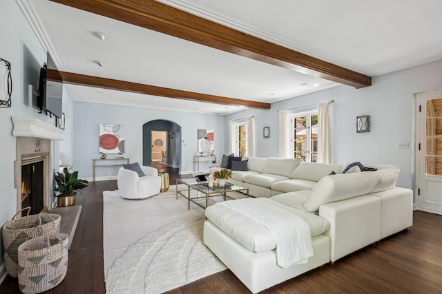 living room with beam ceiling and dark wood-type flooring