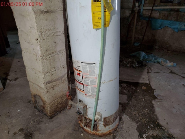 utility room featuring water heater