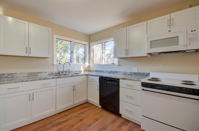 kitchen with white cabinets, light wood-type flooring, white appliances, and sink