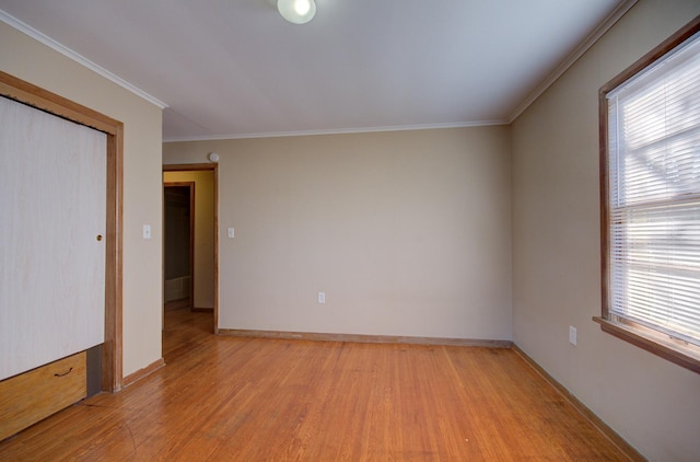 interior space featuring light hardwood / wood-style floors, a wealth of natural light, and crown molding