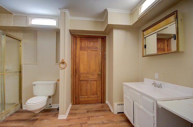 bathroom with vanity, wood-type flooring, an enclosed shower, and ornamental molding