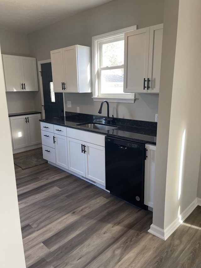 kitchen with black dishwasher, white cabinetry, dark wood-type flooring, and sink