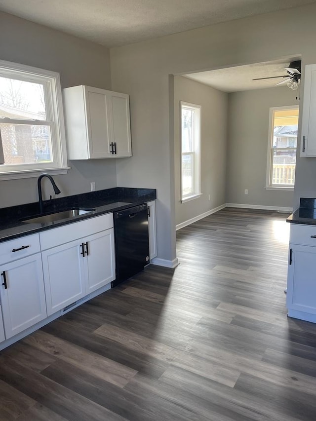 kitchen featuring black dishwasher, dark hardwood / wood-style floors, and white cabinetry