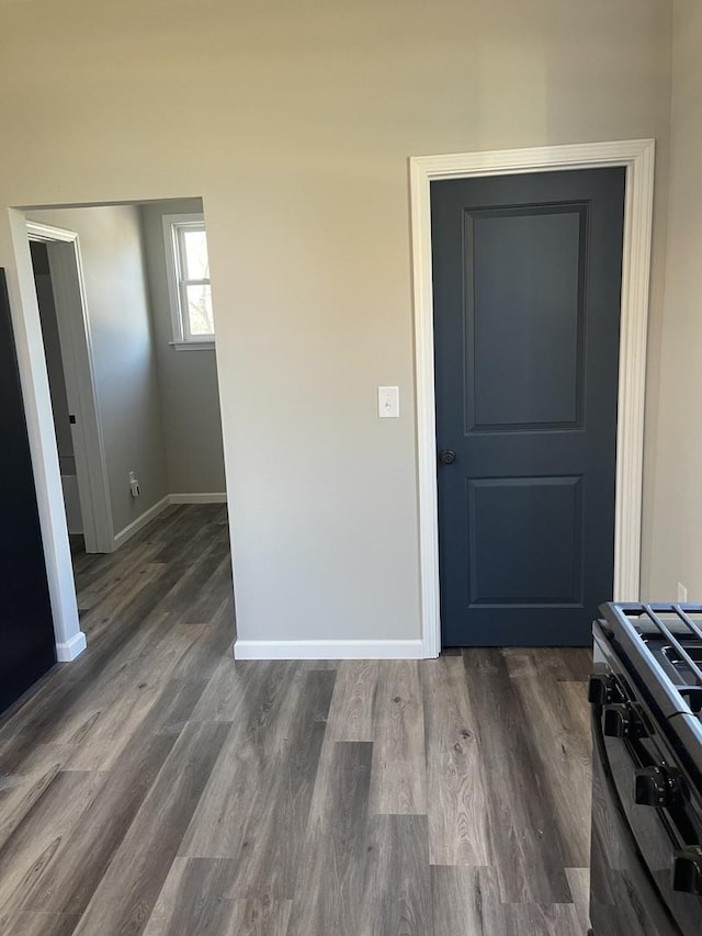 interior space with dark hardwood / wood-style flooring and range with gas stovetop