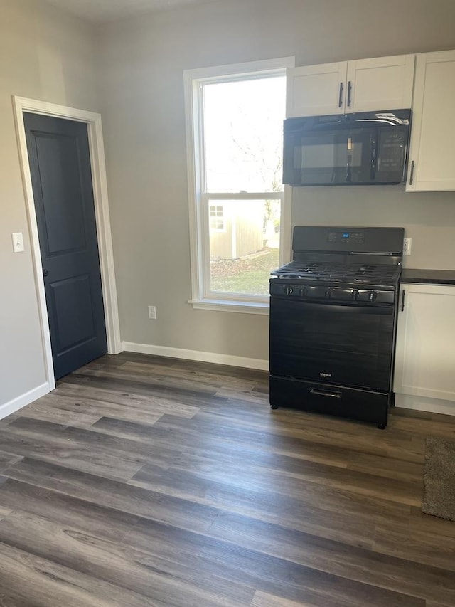 kitchen with dark wood-type flooring, white cabinets, and black appliances