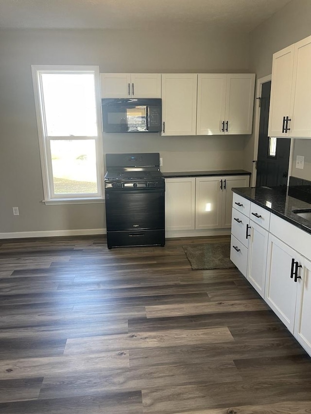 kitchen featuring black appliances, white cabinetry, dark wood-type flooring, and dark stone counters