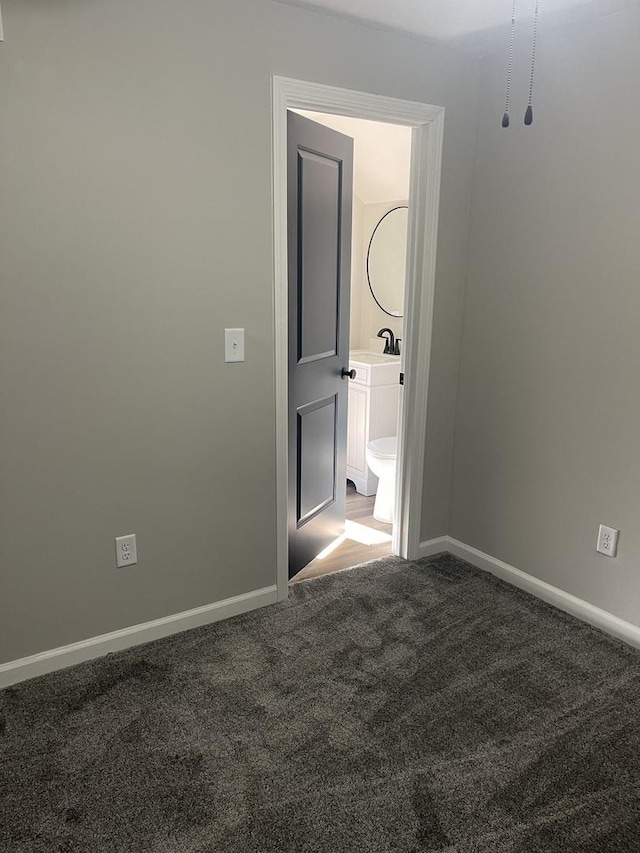 spare room featuring carpet flooring and sink