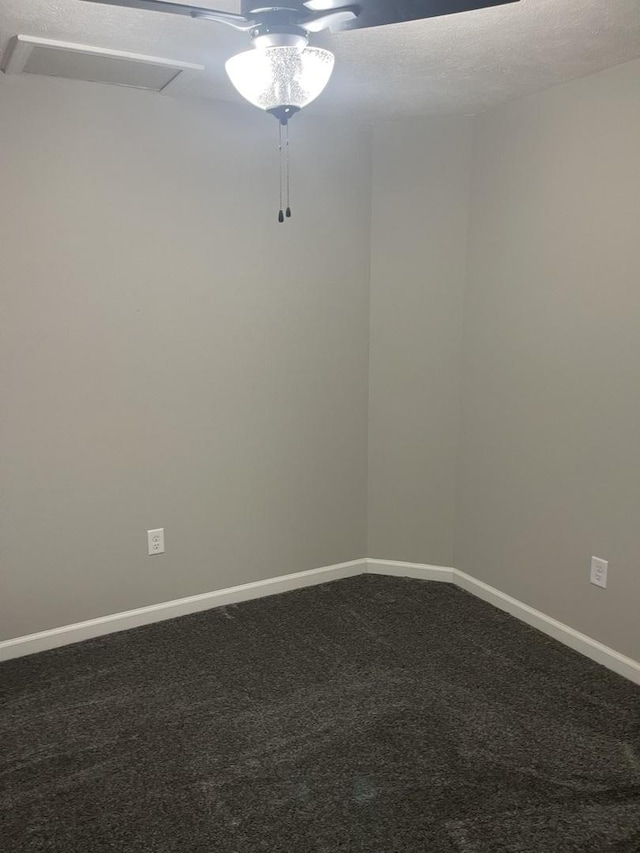 carpeted spare room with ceiling fan and a textured ceiling