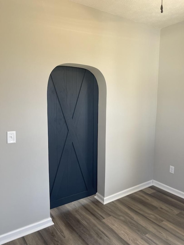 room details featuring hardwood / wood-style floors and a textured ceiling