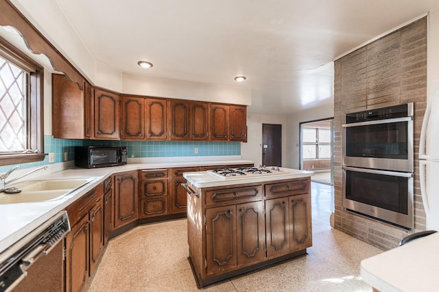 kitchen featuring sink, backsplash, and appliances with stainless steel finishes