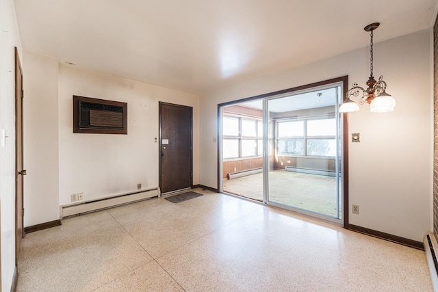 interior space with a notable chandelier, a wall unit AC, and a baseboard radiator