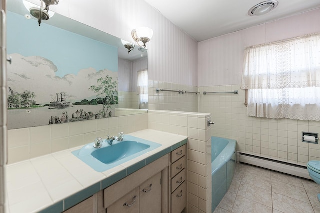 bathroom featuring tile patterned flooring, a tub to relax in, tile walls, a baseboard radiator, and vanity